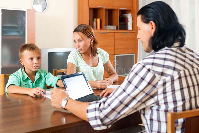Parent and teenager son talking with employee stock images Parent and teenager son talking with employee stock images