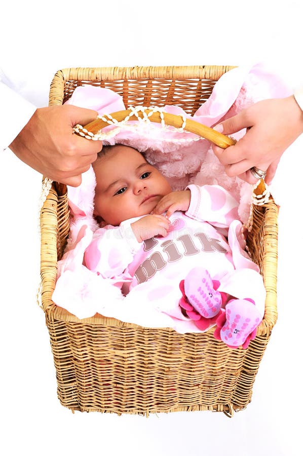 Parents carrying newborn baby in basket