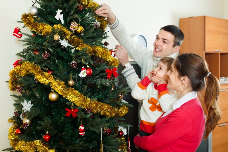 Parents and Child Preparing for Christmas Stock Photo - Image of color ...