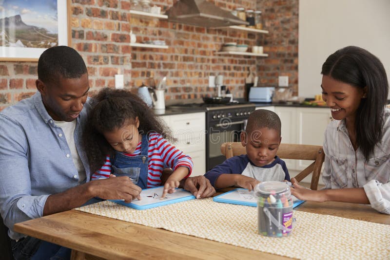 Parents And Children Drawing On Whiteboards At Table royalty free stock photo
