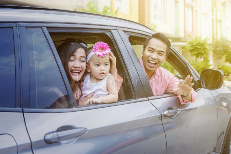 Parents and cute child looking out car windows stock photo Parents and cute child looking out car windows stock photo