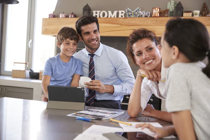 Parents Helping Children With Homework Before Going To Work