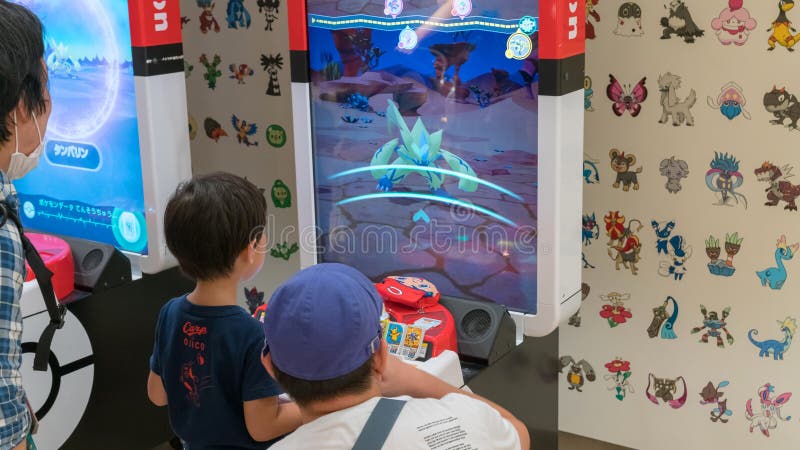 Parents with their children playing Pokemon branded arcade video games at Pokemon Center, Tokyo, Japan stock images Parents with their children playing Pokemon branded arcade video games at Pokemon Center, Tokyo, Japan stock images