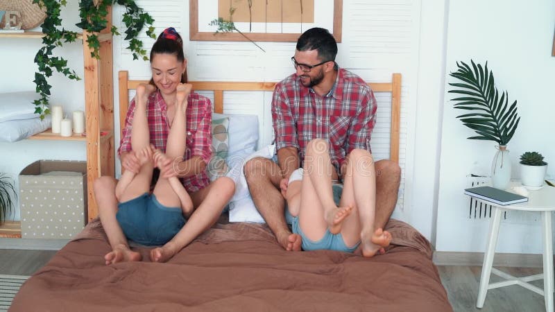 Parents Tickle Daughters, Sit on Bed, Laugh and Have Good Time, Happy Family Stock Footage - Video of caucasian, family: 152922580
