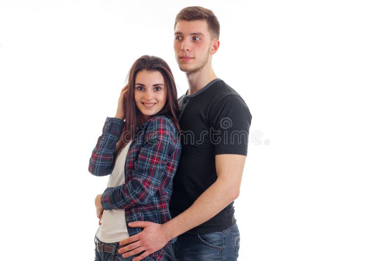 Pares alegres novos que estão junto e menina de sorriso imagens de stock Pares alegres novos que estão junto e menina de sorriso imagens de stock
