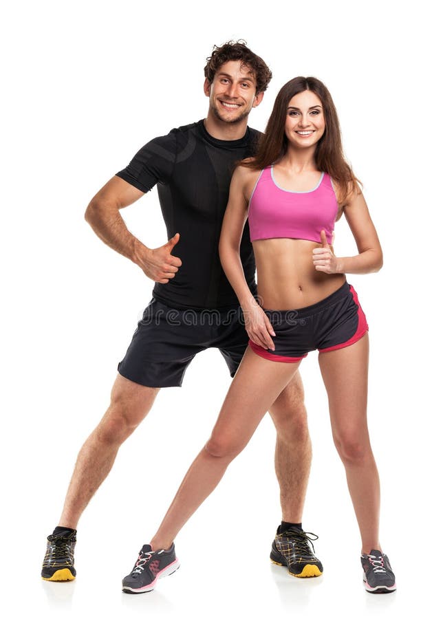 Pares atléticos - homem e mulher com polegar acima no branco foto de stock Pares atléticos - homem e mulher com polegar acima no branco foto de stock