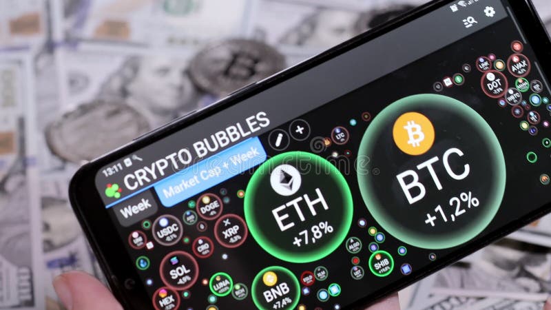 Pares criptodivisa. gráfico de burbujas. índice de interés baja números de crecimiento en una pantalla de smartphone en una aplica