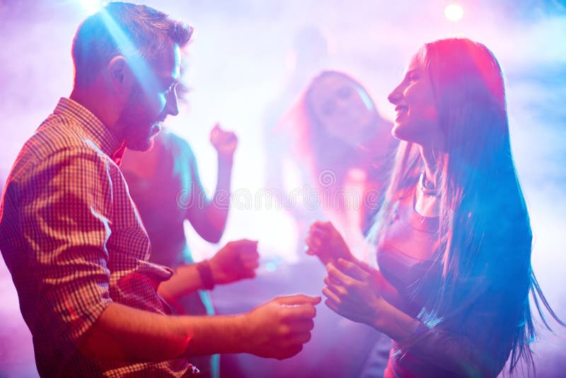 Happy young couple dancing in night club. Happy young couple dancing in night club