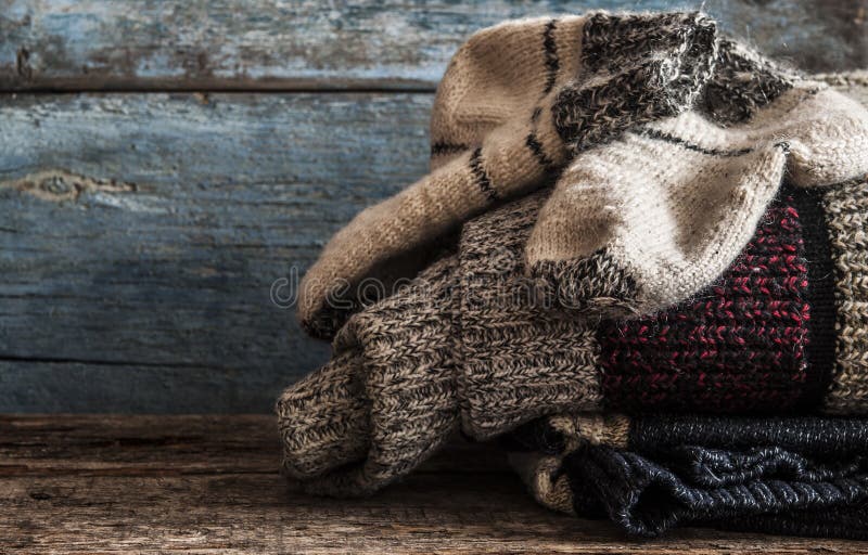 Knitted handmade wool socks on wooden boards close-up. Knitted handmade wool socks on wooden boards close-up