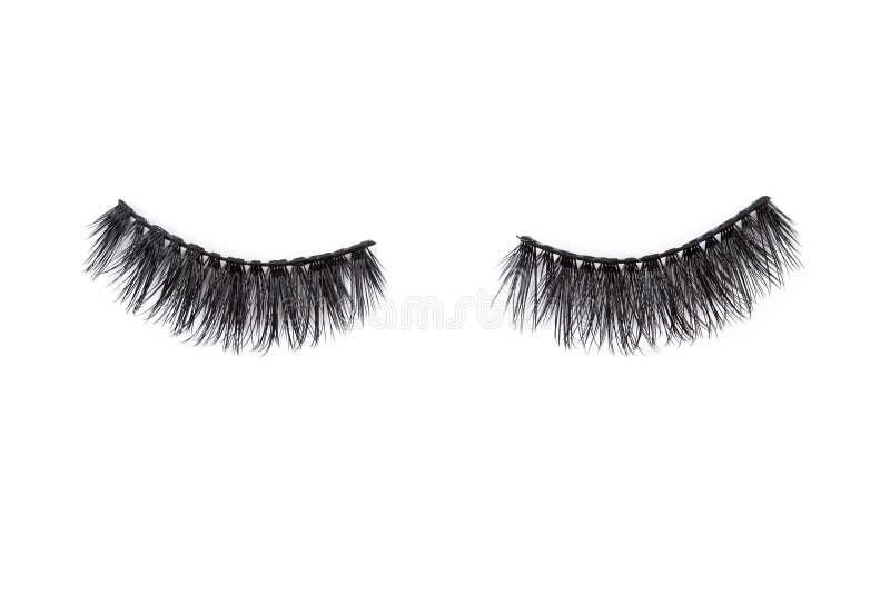 Pair of long false lashes over the white background. Style, trend, fashion concept. Pair of long false lashes over the white background. Style, trend, fashion concept
