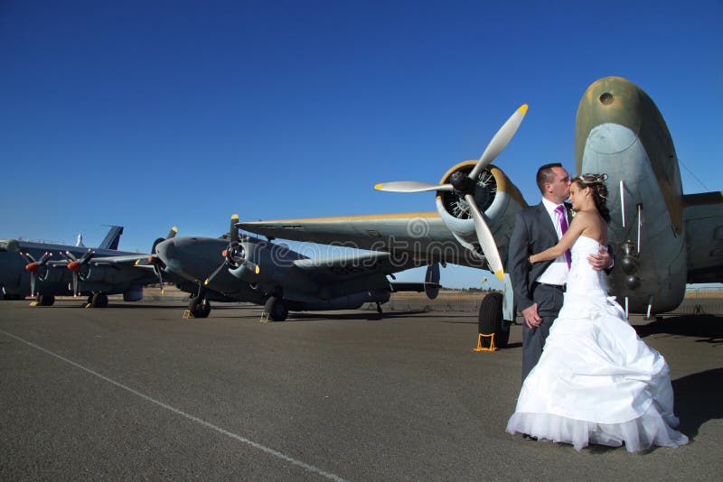 Pares de la boda con los aeroplanos del vintage imagen de archivo libre de regalías Pares de la boda con los aeroplanos del vintage imagen de archivo libre de regalías
