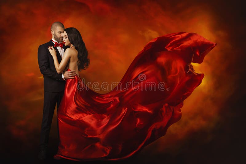 Elegant Couple, Dancing Woman in Red Dress Fluttering Flying on wind and Man in Black Suit, Love Beauty Portrait. Elegant Couple, Dancing Woman in Red Dress Fluttering Flying on wind and Man in Black Suit, Love Beauty Portrait