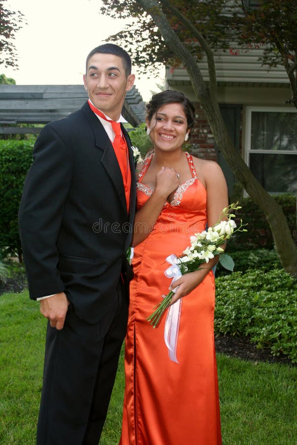 Teenage couple in prom attire, taken in an outdoor setting. Teenage couple in prom attire, taken in an outdoor setting.