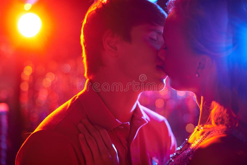 Romantic couple kissing on dance-floor in nightclub. Romantic couple kissing on dance-floor in nightclub