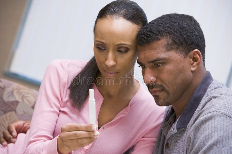Couple looking at negative home pregnancy test. Couple looking at negative home pregnancy test