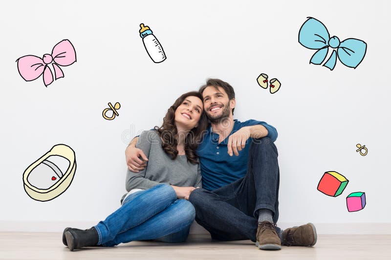 Pares que sueñan a un bebé imagen de archivo libre de regalías Pares que sueñan a un bebé imagen de archivo libre de regalías