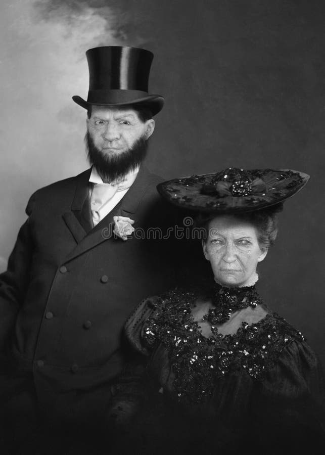 Funny vintage retro love couple. The husband and wife or man and woman have mean, sour looks on their faces. The romance is gone from this marriage! Male wearing a top hat. Funny vintage retro love couple. The husband and wife or man and woman have mean, sour looks on their faces. The romance is gone from this marriage! Male wearing a top hat.