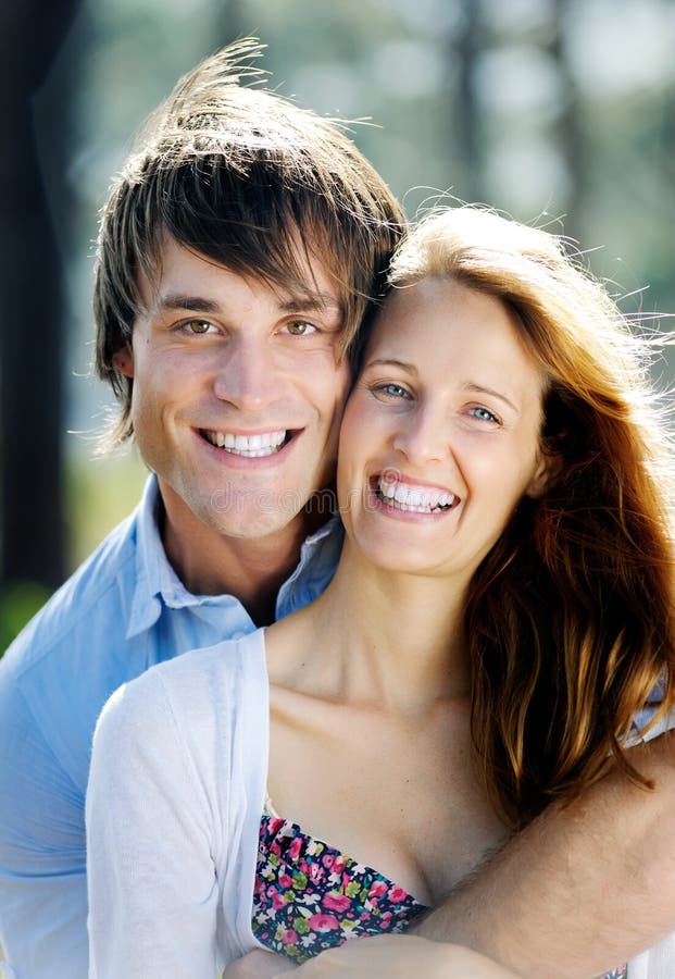 Good looking couple in love smiles widely for a close up portrait. Good looking couple in love smiles widely for a close up portrait