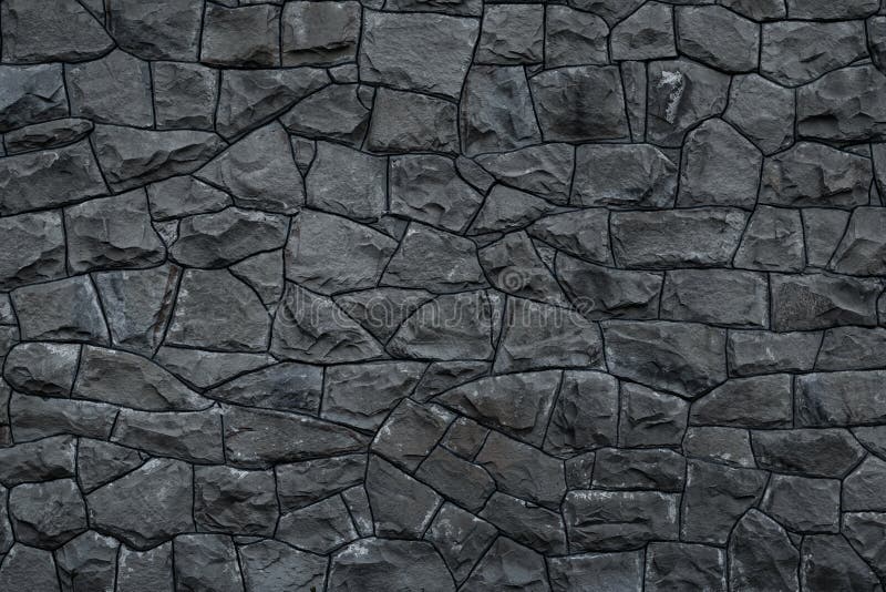 Parete di pietra sporca grigia Struttura di granito grigio Fondo approssimativo scuro delle rocce La facciata stagionata della co fotografie stock Parete di pietra sporca grigia Struttura di granito grigio Fondo approssimativo scuro delle rocce La facciata stagionata della co fotografie stock