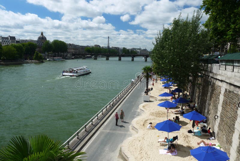 View of Paris-Plage and the Seine. Paris-plages are temporarily transformed roads along the Seine river, into beaches. View of Paris-Plage and the Seine. Paris-plages are temporarily transformed roads along the Seine river, into beaches.