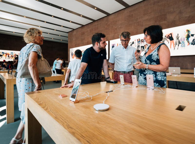 A Genius Bar Reservations Sign at an Apple Store in Front of the Genius Bar  Where Apple Employees are Helping Customers Editorial Stock Image - Image  of global, iphone: 237668444