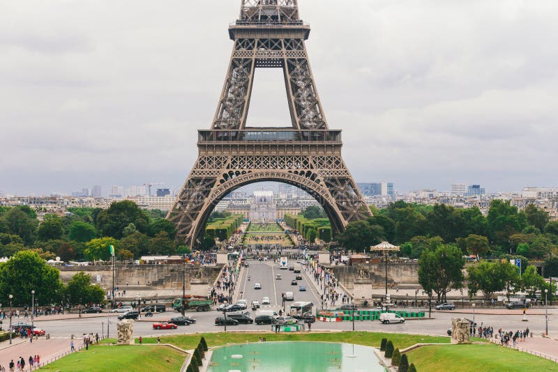 Paris, France July 24, 2017: Eiffel Tower close-up of a road with cars and buses traffic from a transporter, passage under an arch