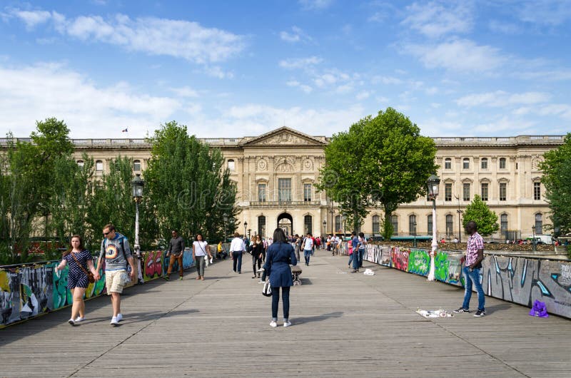 Paris, France - May 13, 2015: People visit the Pont des Arts bridge stock photography Paris, France - May 13, 2015: People visit the Pont des Arts bridge stock photography