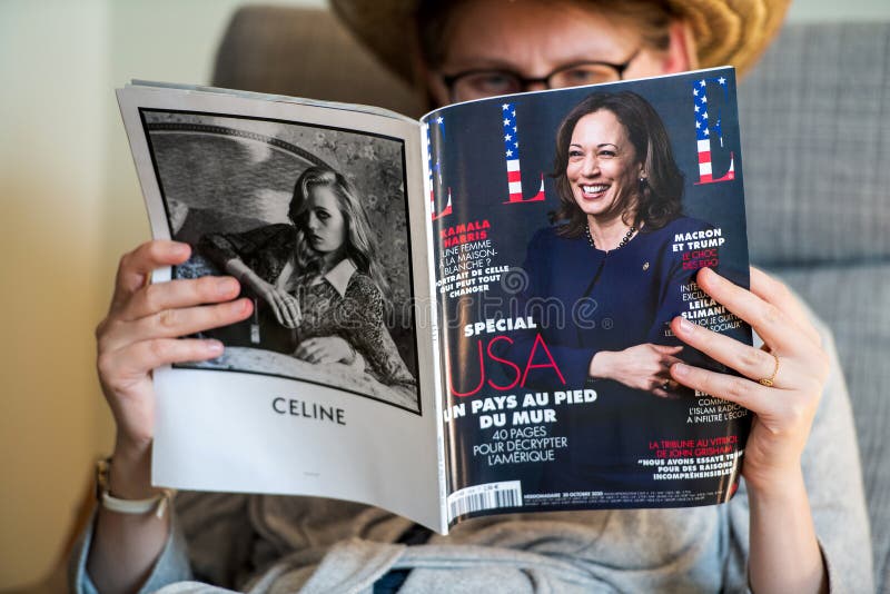 Paris, France - Nov 5, 2020: Woman reading in living room the latest Elle Magazine featuring on cover Kamala Harris Democratic vice presidential nominee for the 2020 election