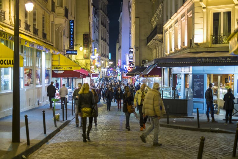 Paris, FRANCE - OCTOBER 19: Night shot of busy Rue de la Huchette with lots of pedestrians. October 19, 2013 in Paris. royalty free stock photography Paris, FRANCE - OCTOBER 19: Night shot of busy Rue de la Huchette with lots of pedestrians. October 19, 2013 in Paris. royalty free stock photography
