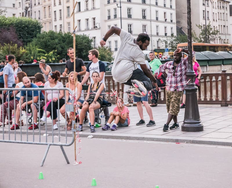 Paris skater leaps plastic barricade as people look on