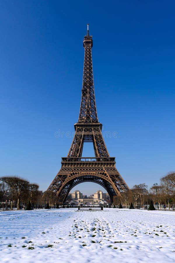 Paris - Snowy Eiffel Tower. The Eiffel Tower and the Chaillot Palace seen from the snowy Champ de Mars Paris - Snowy Eiffel Tower. The Eiffel Tower and the Chaillot Palace seen from the snowy Champ de Mars