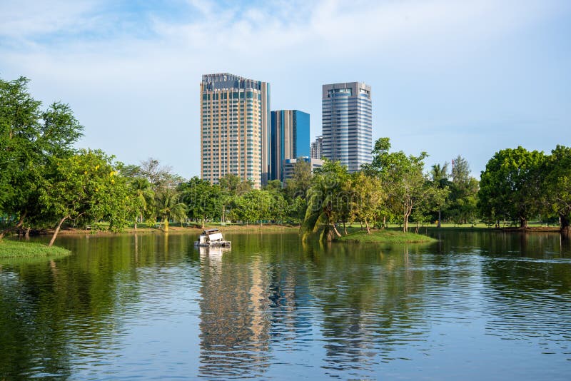 Park in Bangkok city with modern business building