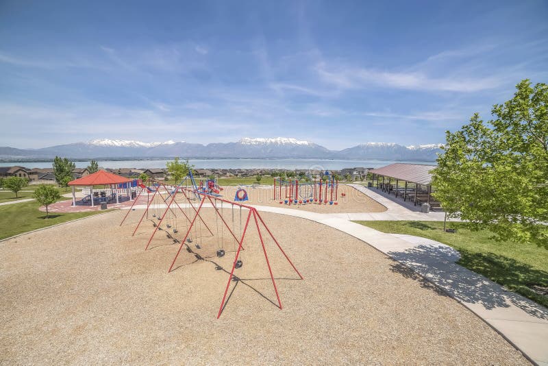 Park overlooking homes lake and snowy mountain under blue sky on a sunny day royalty free stock images Park overlooking homes lake and snowy mountain under blue sky on a sunny day royalty free stock images