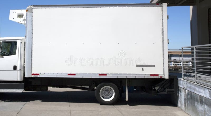 Parked refrigerated truck at loading dock