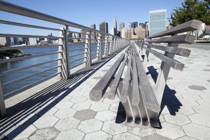 This picture was taken in Gantry Park in Queens, it looks along the benches directly at the skyline of NYC skyline, including the United Nations building and the Empire State building. This picture was taken in Gantry Park in Queens, it looks along the benches directly at the skyline of NYC skyline, including the United Nations building and the Empire State building.