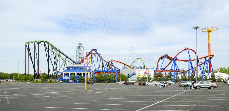 Loops and tracks of metal roller coaster rides and parking lot entrance at Six Flags Great Adventure amusement park. Loops and tracks of metal roller coaster rides and parking lot entrance at Six Flags Great Adventure amusement park.