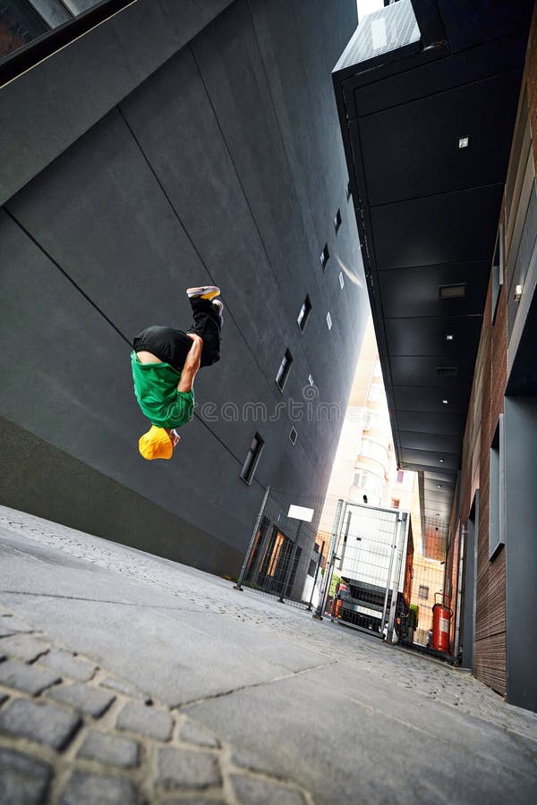 Parkrunner's athletic form creates striking visual against sleek lines of city architecture, reflecting vitality of royalty free stock images