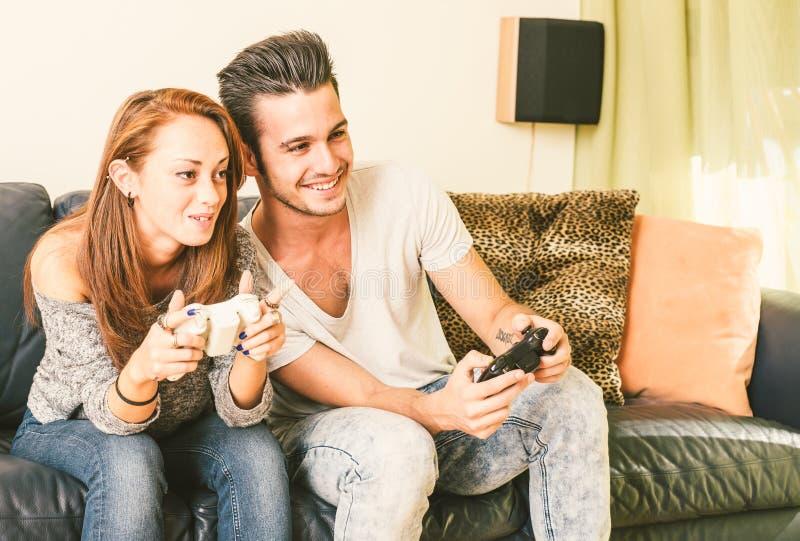 Young couple playing video games at home. Young couple playing video games at home