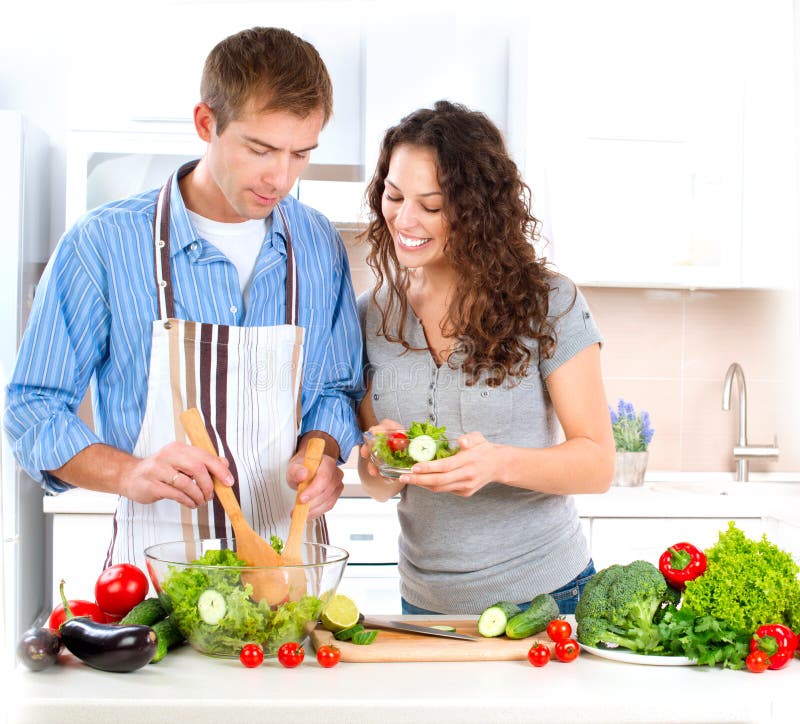 Happy Couple Cooking Together. Dieting. Healthy Food. Happy Couple Cooking Together. Dieting. Healthy Food