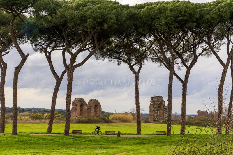 Rome, Italy - March 3, 2024: Park of the Aqueducts (Parco degli Acquedotti), an archeological public park in Rome, Italy, part of the Appian Way Regional Park, with monumental ruins of Roman aqueducts. Rome, Italy - March 3, 2024: Park of the Aqueducts (Parco degli Acquedotti), an archeological public park in Rome, Italy, part of the Appian Way Regional Park, with monumental ruins of Roman aqueducts.