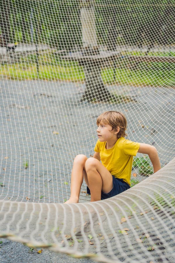 Parque Infantil De Redes De Práctica. Niño Juega En El Patio De