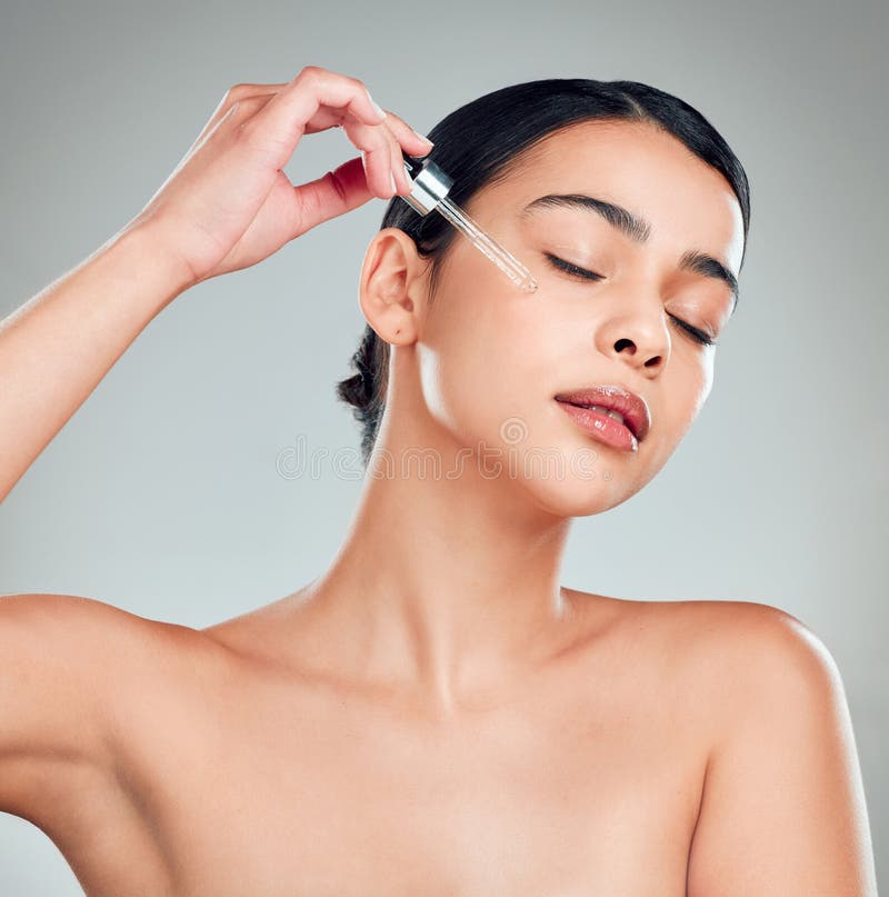 Parrucca e cosmetici con siero e donna in studio per dropper vitamina c ed estetica. colata di collagene e fotografie stock