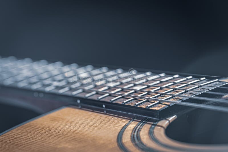 Close-up of a guitar fretboard on a black background