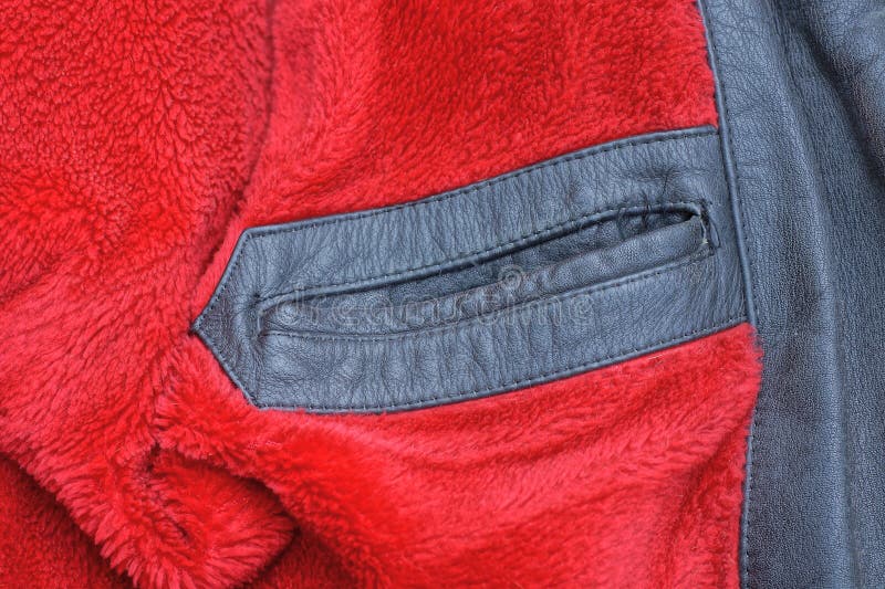 Black leather jacket with a pocket on a red fur lining stock image