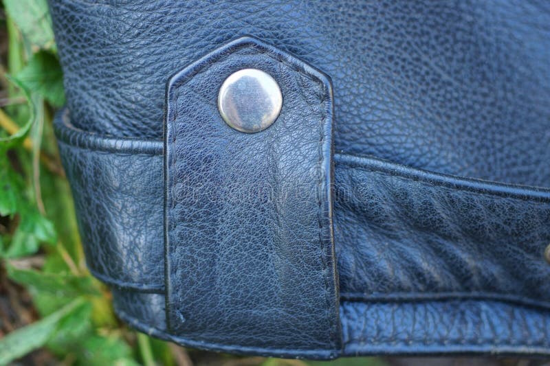 Part of a black leather jacket with a strap royalty free stock photography