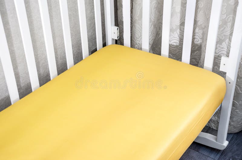 Part of Cot, Close Up. Mattress and Yellow Sheet in White Bed. Stock Photo Image of interior