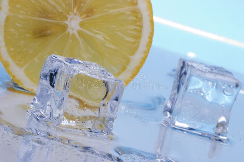 Two ice cubes melted in water and slice of lemon on reflection surface ready to be added to a cocktail. Two ice cubes melted in water and slice of lemon on reflection surface ready to be added to a cocktail