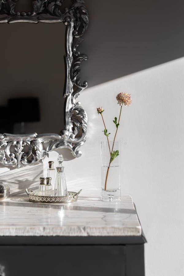 Part of Dressing Table with Vase and Flower Bright by Sunlight on White