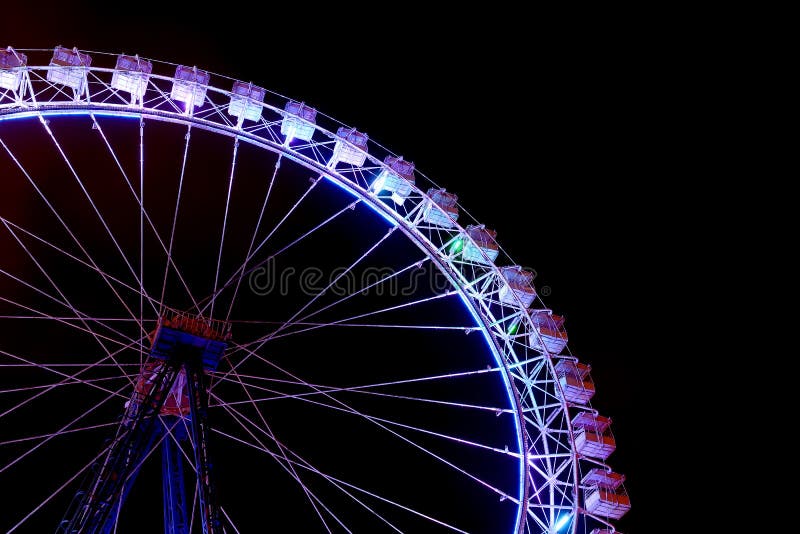 Part of ferris wheel with blue lighting at night royalty free stock photos Part of ferris wheel with blue lighting at night royalty free stock photos