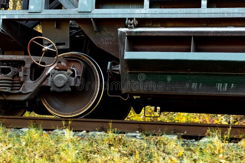 Part of a Freight Car with Massive Wheels during the Movement of the